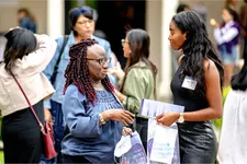 two women speaking at event