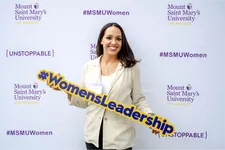 woman smiling holding a 