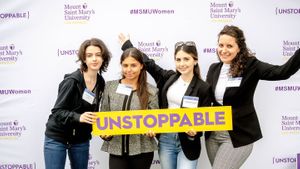 group of women posing in front of MSMU backdrop