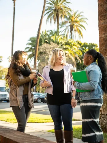 student and adult smiling together