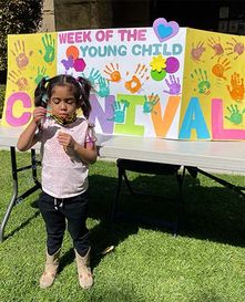 A child blowing bubbles in front of a decorated table