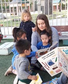 toddlers sitting on the ground and reading