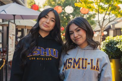 two female students smiling standing outdoors in Little Tokyo wearing ÿ�մ������ sweaters