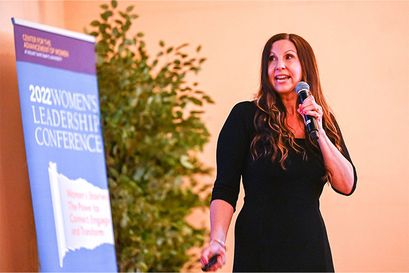 female speaker talking on stage