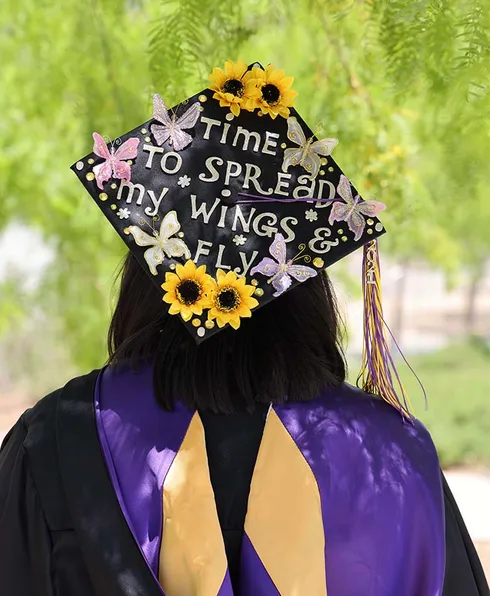 graduation cap that reads, 
