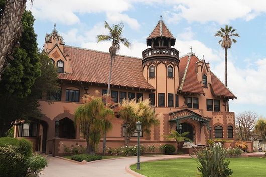 doheny mansion building with palm trees