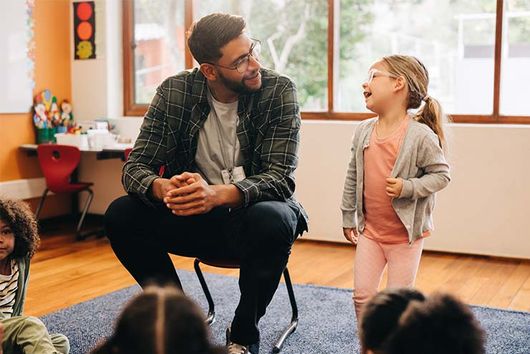 male teacher leading a classoom
