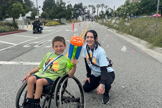 DPT student volunteer at Rancho Los Amigos Roll Around the Ranch event with wheelchair basketball all-star.