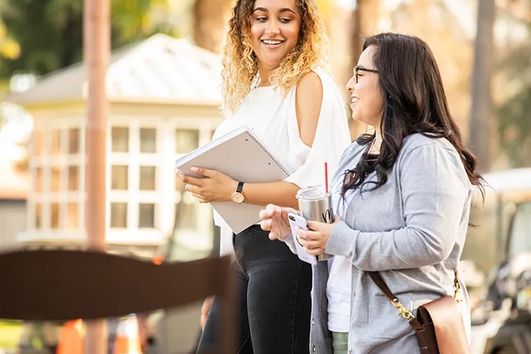 two female students walking and talking on the doheny campus