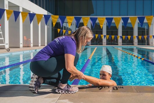 Student getting physical therapy in a pool