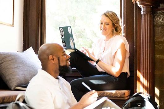 two graduate students sitting discussing