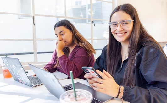 Students using laptops inside