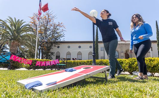 Student playing toss game at the 91ɬ�� Carnival day 2022