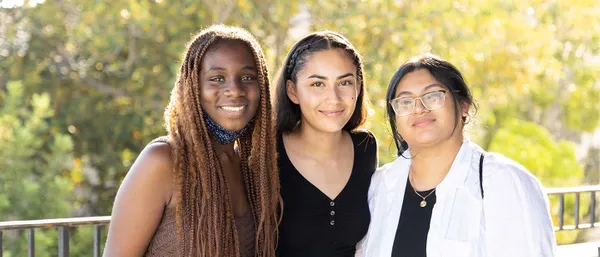 three students smiling