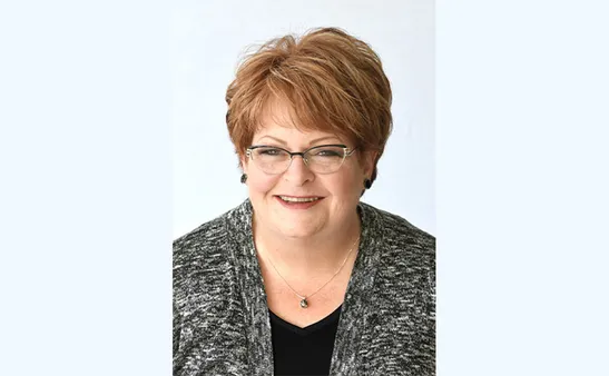 Woman smiling wearing glasses and a jacket
