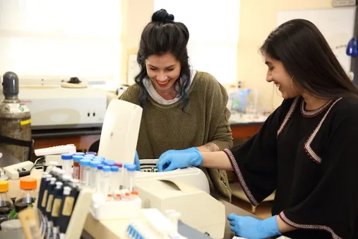 (From left) Mount students Alissa Oakes and Arleen Lamba work together in a campus lab on the NIH-funded research project.
