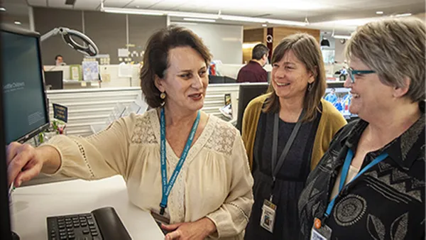 Three women working in a hospital.