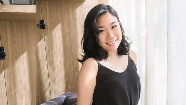 A portrait of a woman smiling at the camera.