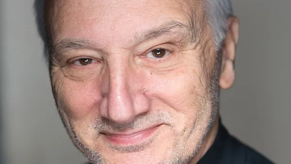 A portrait of a man smiling at the camera.