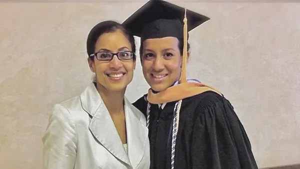 Ruth Racine ’99 at her '11 Uniformed Services University of the Health Sciences graduation in Bethesda, Maryland. With her is sister Blaisy Racine, an RN and also an Army veteran.