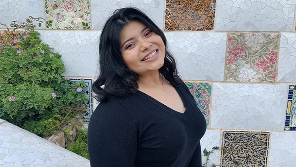 A portrait of a woman smiling at the camera.