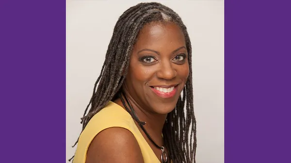 A portrait of a woman smiling at the camera