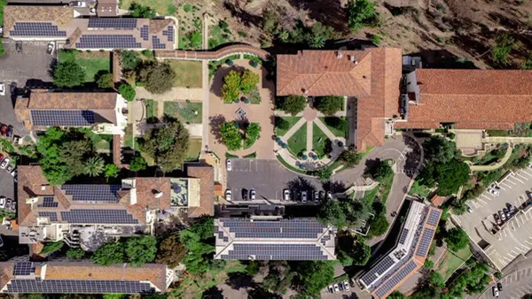 An aerial drone shot of the Chalon campus showing solar panels on building roofs.