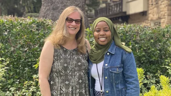 Two women smiling at the camera.