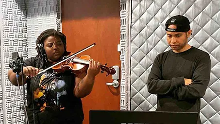 Lalibela Faraba ’25 and professor Derrick Skye at the University's recording studio working on their project.