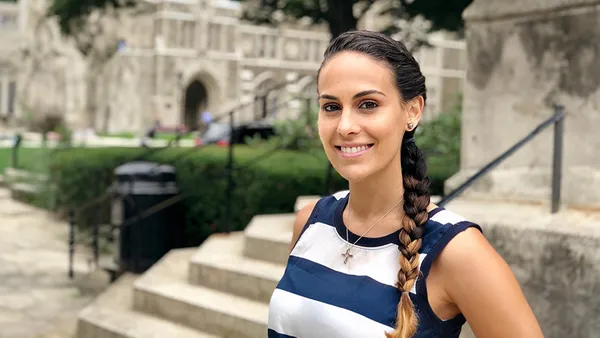 Christie de la Gandara smiling on campus