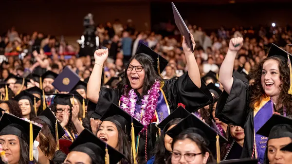 Newly Mount graduates cheering with joy and enthusiasm minutes after receiving their diplomas at the Shrine Auditorium.