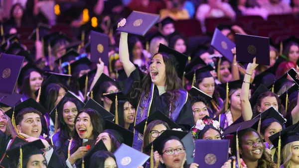 Graduates hold up their diplomas during Commencement 2026, marking the close of their academic journey at Mount Saint Mary's University.