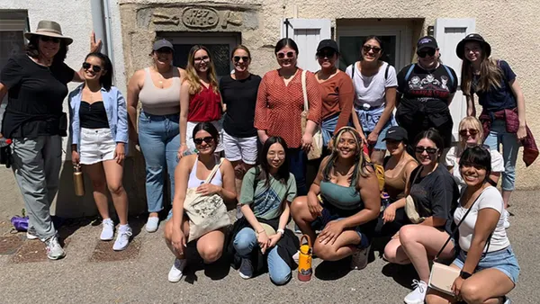 Mount students with President McElaney-Johnson (back row, fifth from left) and Stephanie Cubba, VP of Institutional Advancement (back row, far left).