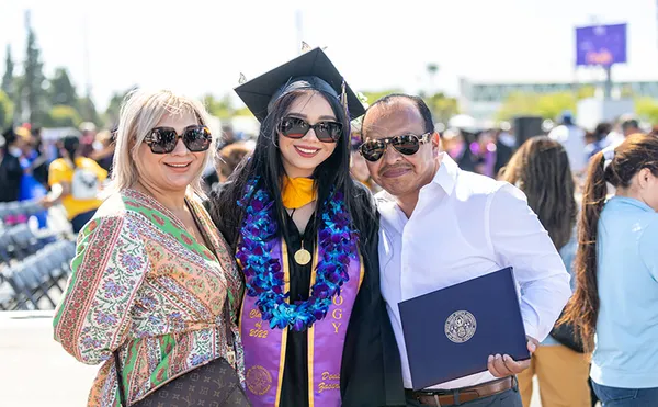 MSMU graduate with her parents at 2022 Commencement