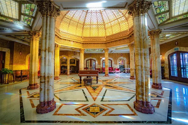 interior shot of a Doheny Mansion room with a piano in the center