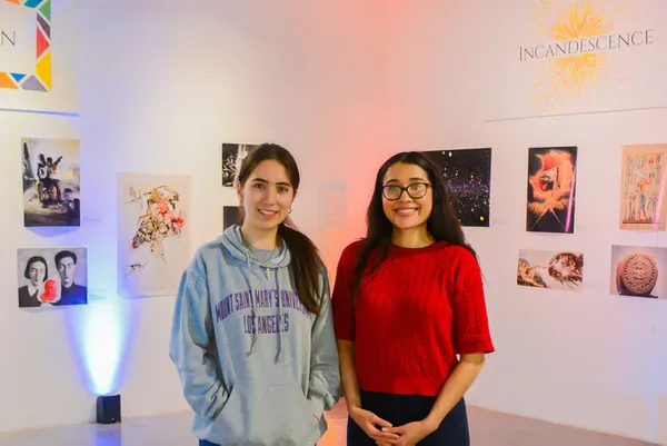 Students standing in front of an art gallery exhibit