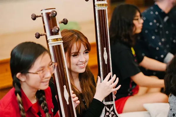 students smiling holding their instruments