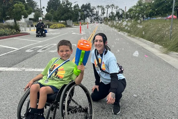 DPT student volunteer at Rancho Los Amigos Roll Around the Ranch event with wheelchair basketball all-star.
