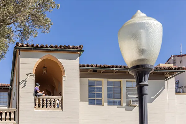 Student sitting off balcony.