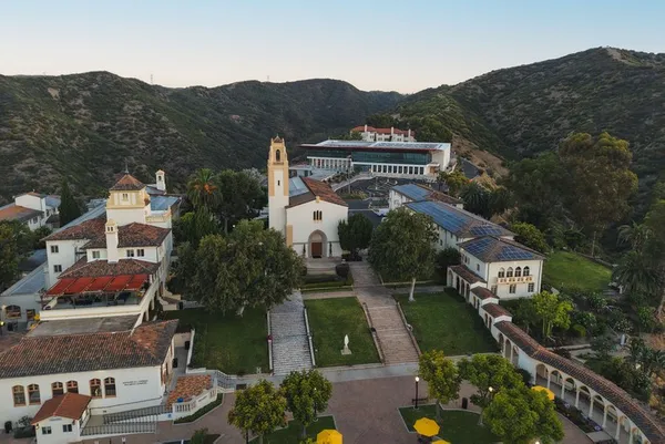 drone shot of chalon campus, showing buildings and mary chapel church against the mountains