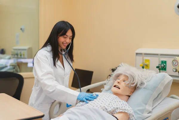 A student practicing techniques on a medical mannequin