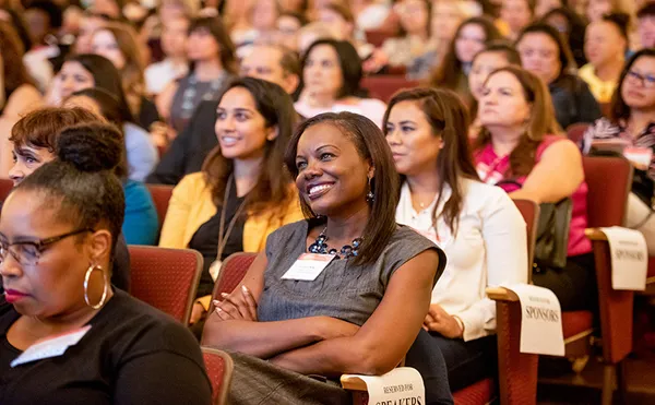 Woman smiling at the Women's Leadership Conference