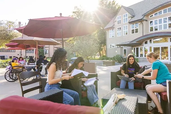 students sitting outdoor on campus studying