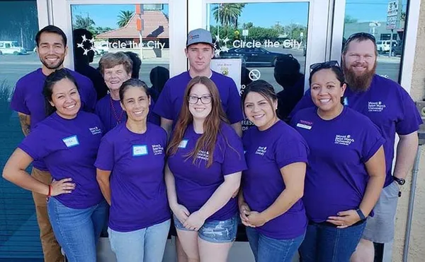 group of alum volunteers wearing purple shirts