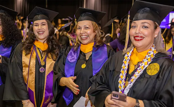 three female weekend, evening and online college graduates smiling