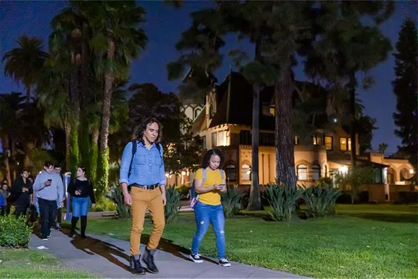 Students Walking on Campus at Night