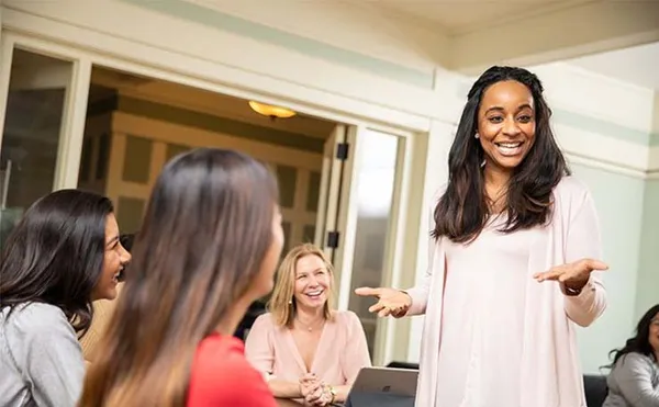 Mount professor teaching and smiling at students.