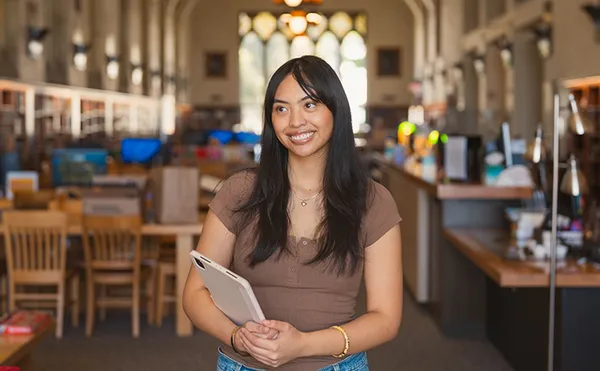 A student smiling in Coe Library