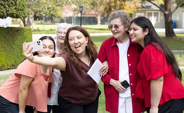 group taking a selfie outdoors together