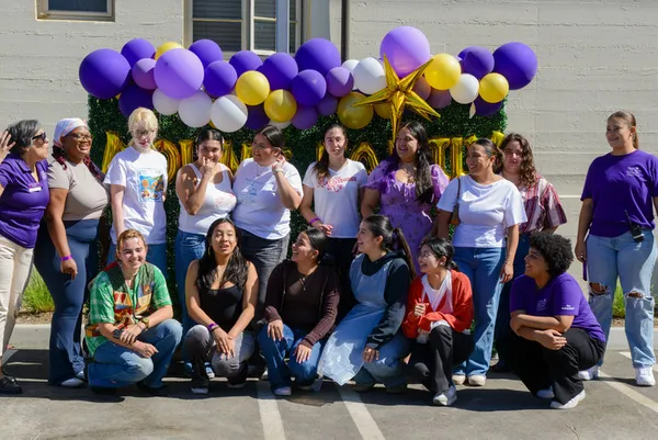 A group of students holding balloons at orientation
